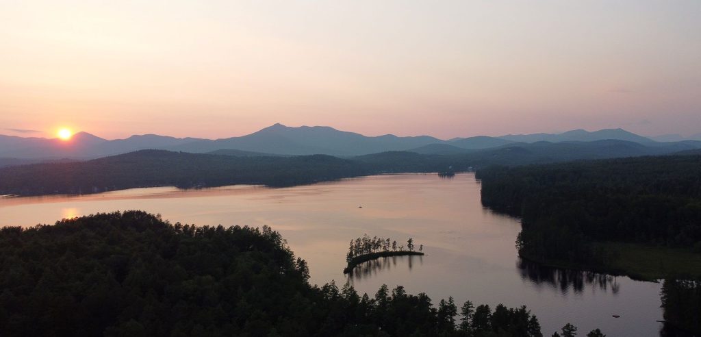 Aerial view of the calm lake at dusk with muted sunset colors.